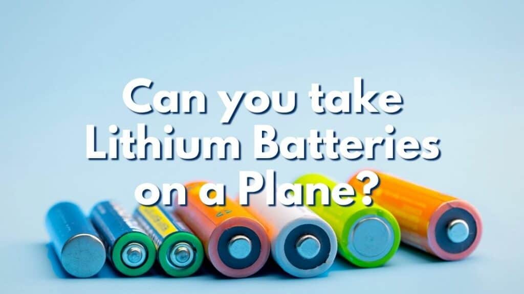 Different colored batteries with text overlay that reads Can you take lithium batteries on planes?