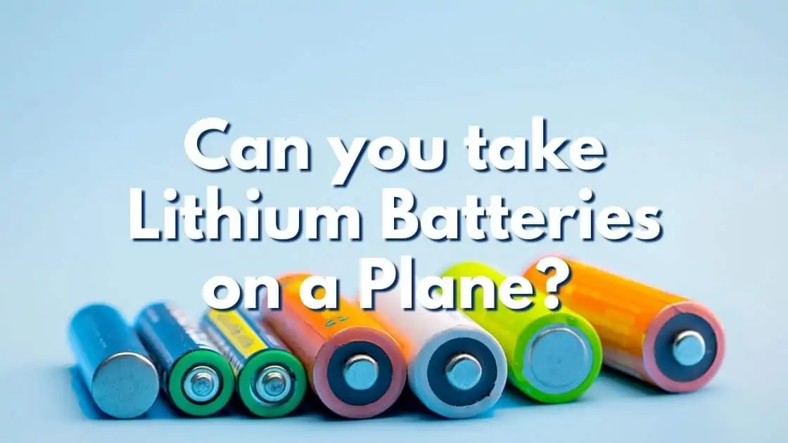 Different colored batteries with text overlay that reads Can you take lithium batteries on planes?