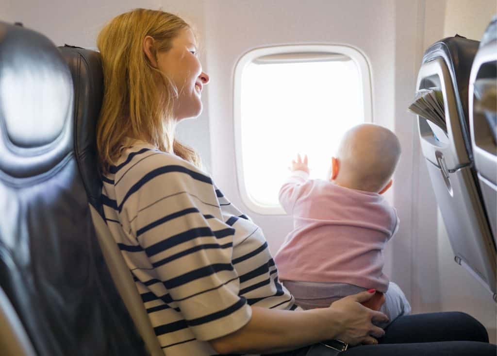 The Best Seats to Book When Flying With Children 2 Flying with kids - baby sitting on lap