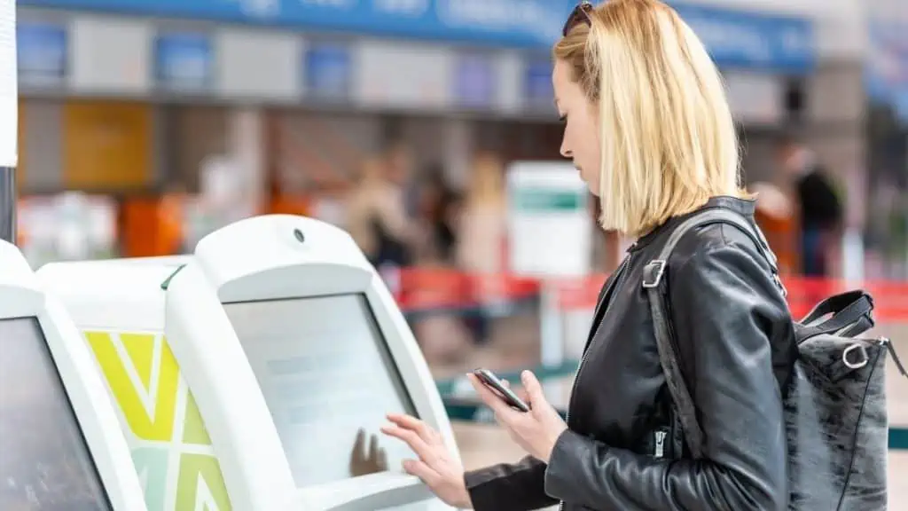 What Does Flying Standby Mean_Woman on kiosk