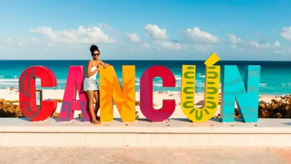 Woman on a beach with word Cancun